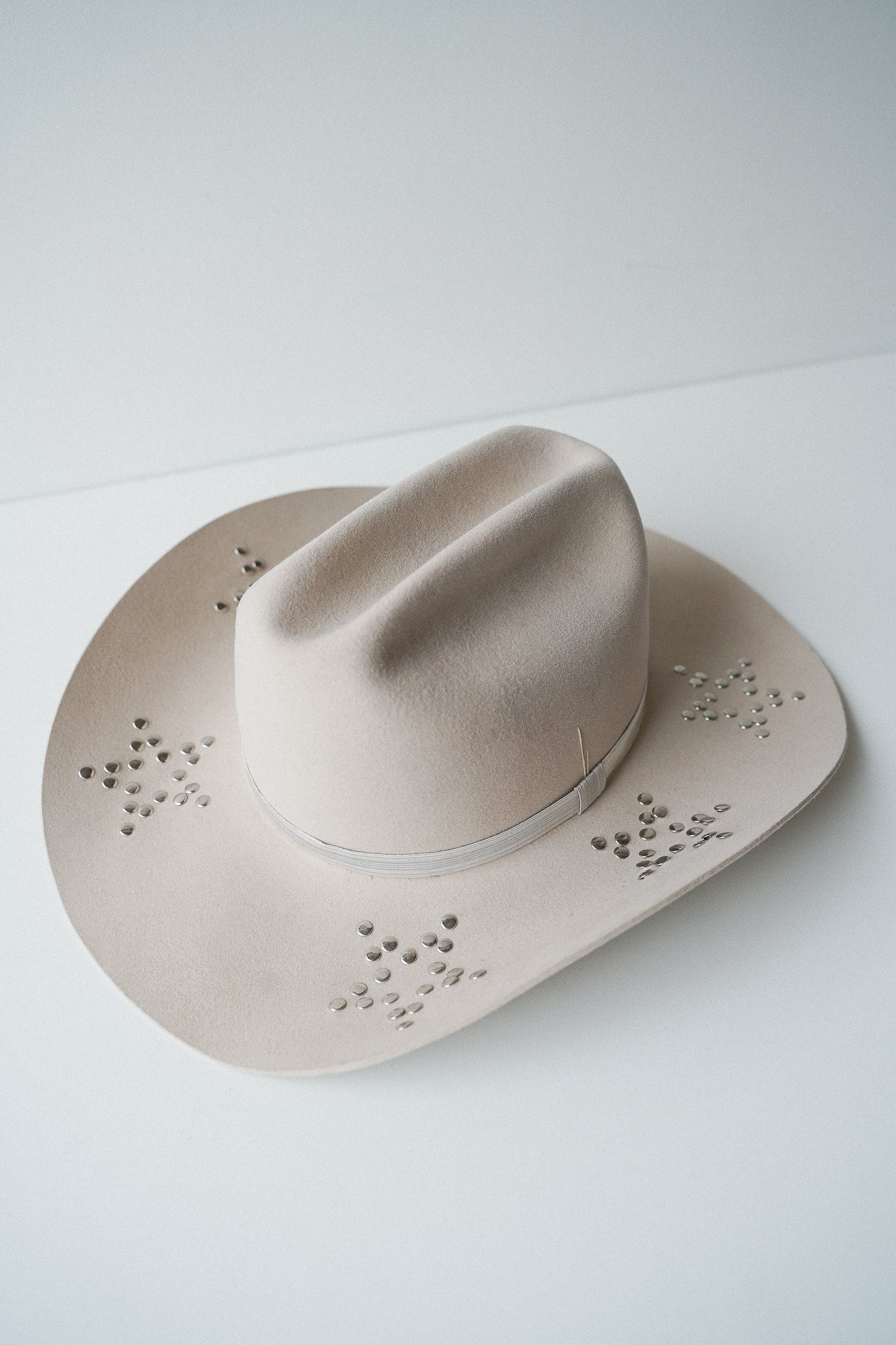 Beige cowboy hat with studs custom design.