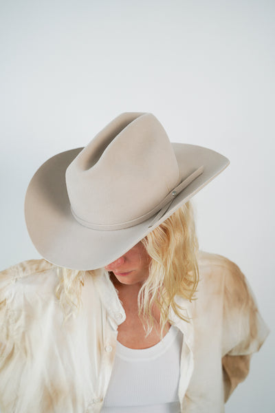 Unisex beige fur felt cowboy hat with a wide brim, self-fabric band, silver. stud detail and center crease, handcrafted by SoonNoon in Stockholm