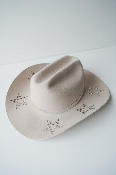 Beige cowboy hat with studs custom design.