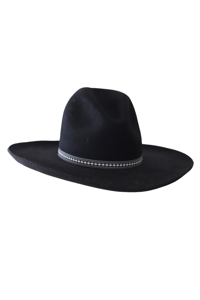 A black felt cowboy hat with a wide brim and a decorative black woven band featuring a row of small white diamond shapes, shown against a plain white background.