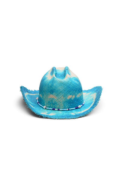 Unisex blue/white tie-dye cowboy straw hat with a wide, flanged brim, frayed edges, and center crease. Seed beads and saltwater pearls detail, handcrafted by SoonNoon in Stockholm