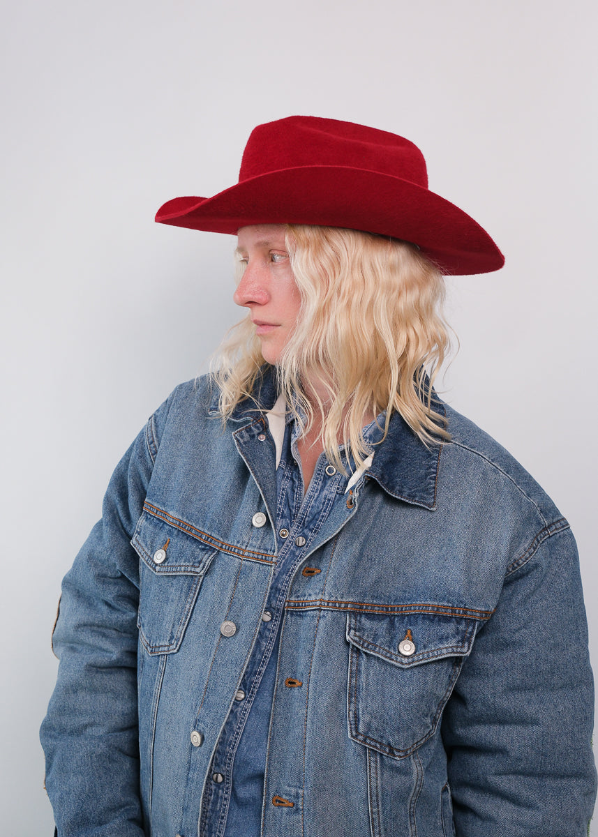 Unisex red fur felt cowboy hat with a wide brim, self-fabric band, silver. stud detail and center crease, handcrafted by SoonNoon in Stockholm