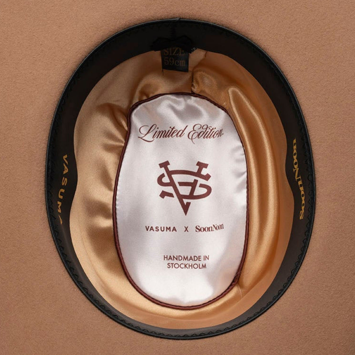A top-down view of a brown felt cowboy hat with a satin inner liner and leather sweatband.
