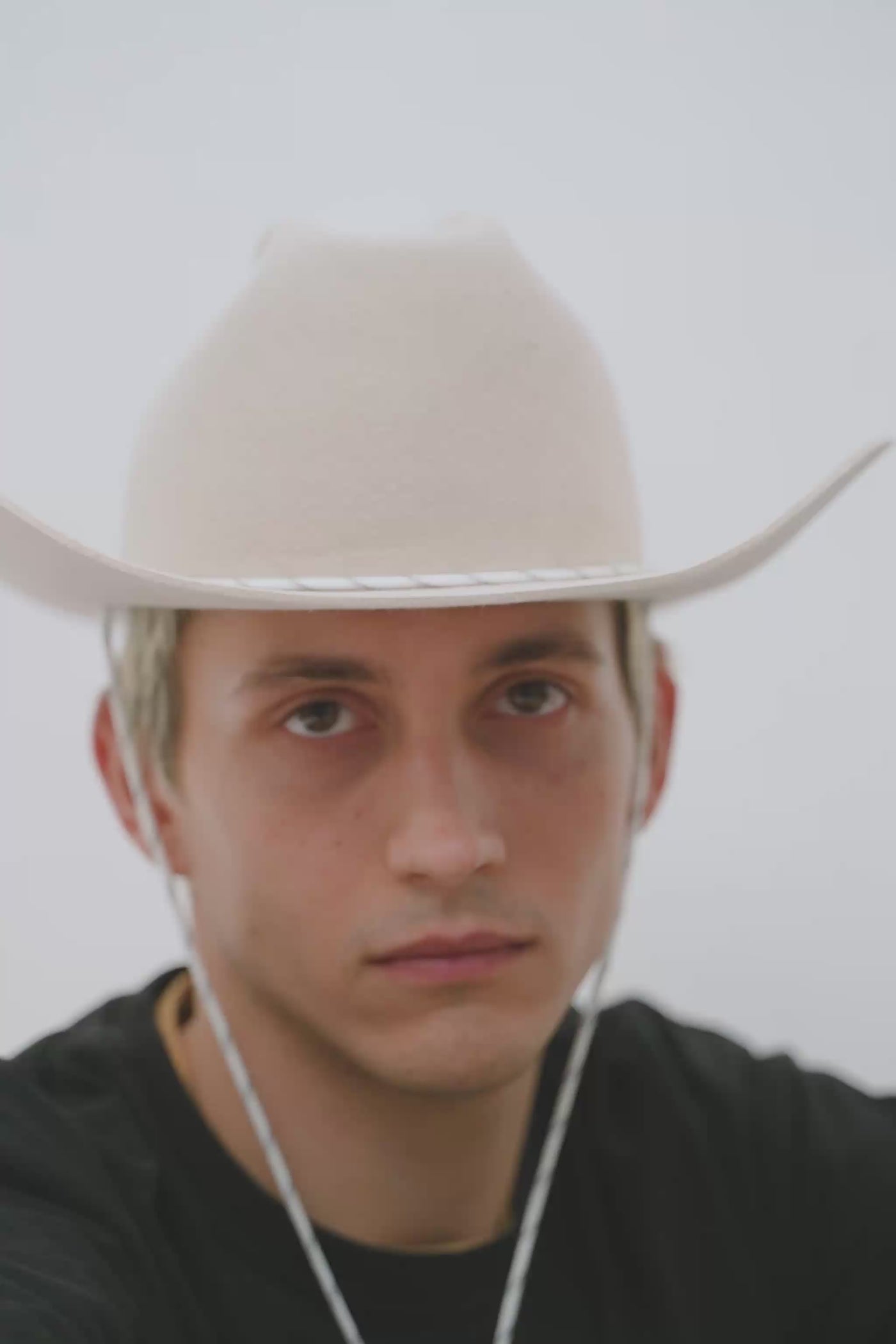 Beige cowboy hat with a white paracord chin strap detail, handcrafted by SoonNoon