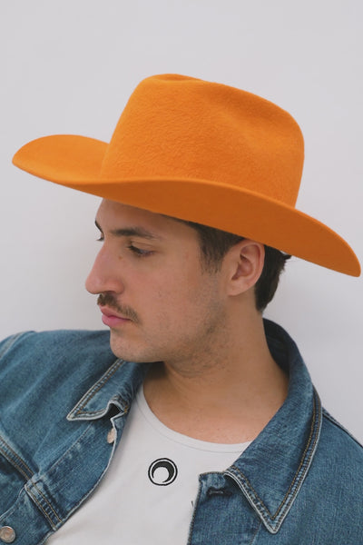 Orange cowboy 100% velour fur felt hat with a wide brim and center crease. Unisex hat style in various sizes and colors. We ship worldwide. Shop now. Each SoonNoon hat is handmade with unique character in Stockholm, Sweden.
